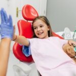 Many children experience anxiety about visiting the dentist. Understanding the reasons behind this fear can help parents and dental professionals create a more comfortable experience. In this blog post, we’ll explore why kids fear the dentist and share tips to reduce stress during dental visits. Common Reasons Kids Fear the Dentist Fear of the Unknown Children often fear what they don’t understand. A dental office can be an intimidating environment, with unfamiliar tools, sounds, and smells. Many kids don’t know what to expect during a dental exam, which can cause anxiety. Previous Negative Experiences A previous bad experience at the dentist can make future visits more stressful. If a child has experienced pain or discomfort during a past appointment, they may associate the dentist with negative feelings. Separation Anxiety Younger children may experience fear when they are separated from their parents during a dental visit. This anxiety can heighten their overall stress and discomfort. Fear of Pain The idea that a dental procedure might hurt is a significant cause of anxiety for children. Even routine check-ups can be frightening if they associate them with discomfort or pain. Stories from Others Kids may hear scary stories about the dentist from siblings or friends, which can increase their fear. Hearing others talk about painful or negative experiences at the dentist can make children apprehensive about their own visit. Tips to Make Dental Visits Less Stressful Start Early The earlier you introduce children to the dentist, the better. Bringing a child for their first dental visit when they’re young helps them become familiar with the environment. It’s recommended that children see the dentist by their first birthday. Early visits focus on preventive care and getting children used to the dental office. Use Positive Language When talking about the dentist, avoid using negative words like "pain" or "hurt." Instead, use positive language. You can explain the dentist as someone who helps keep their teeth strong and healthy. Use words like "clean," "shiny," or "healthy" when describing what happens during the visit. Role Play at Home You can prepare your child by role-playing a visit to the dentist at home. Use a toothbrush and count their teeth, then let them play the role of the dentist. This can help them understand what will happen and make the actual visit less intimidating. Choose a Child-Friendly Dentist Pediatric dentists are specially trained to work with children and know how to make the experience more pleasant. These offices are often designed with children in mind, featuring colourful decorations, toys, and even videos to distract kids during treatment. Bring a Comfort Item Allow your child to bring a favourite toy or blanket to the appointment. Having something familiar and comforting with them can help reduce their anxiety and make them feel safer in the unfamiliar environment. Explain Procedures in Simple Terms Before the visit, explain what will happen in simple, non-scary terms. You might say, “The dentist is going to count your teeth and make sure they are nice and strong.” This helps reduce fear by giving the child a clear understanding of what to expect. Stay Calm and Positive Children often pick up on their parents’ emotions. If you’re calm and positive about the dentist visit, your child is more likely to feel the same way. Avoid showing any signs of anxiety yourself, as this can increase your child’s fear. Use Distractions Some dental offices offer distractions such as cartoons or music during the appointment. These can be helpful in taking the child’s mind off the procedure. If your dentist doesn’t provide these, you can bring along a tablet or phone with your child’s favourite show to help them relax. Praise and Reward Praise your child for being brave during the visit. Positive reinforcement can make a big difference. You can also offer a small reward after the appointment, such as a sticker or a special treat. This can help turn the dentist into a more positive experience. Use Sedation When Necessary For children with severe anxiety, sedation dentistry can be a helpful option. Nitrous oxide (laughing gas) or mild sedatives can help keep a child calm during more complicated procedures. Talk to your dentist about this option if necessary. What to Do After the Visit Once the dental visit is over, it’s important to continue the positive experience at home. Talk to your child about how brave they were and reinforce the idea that the dentist is there to help them stay healthy. Encourage regular brushing and flossing so that your child continues to feel in control of their dental health. Conclusion Dental visits don’t have to be a source of fear for children. By understanding why kids may be anxious about the dentist and using the right strategies, you can help make their experience more pleasant. Starting early, using positive language, and choosing a child-friendly dentist are key steps in reducing fear. With these tips, you can ensure your child’s dental visits are stress-free and set the foundation for lifelong dental health.