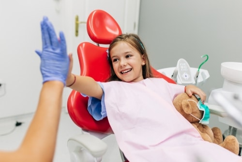 Many children experience anxiety about visiting the dentist. Understanding the reasons behind this fear can help parents and dental professionals create a more comfortable experience. In this blog post, we’ll explore why kids fear the dentist and share tips to reduce stress during dental visits. Common Reasons Kids Fear the Dentist Fear of the Unknown Children often fear what they don’t understand. A dental office can be an intimidating environment, with unfamiliar tools, sounds, and smells. Many kids don’t know what to expect during a dental exam, which can cause anxiety. Previous Negative Experiences A previous bad experience at the dentist can make future visits more stressful. If a child has experienced pain or discomfort during a past appointment, they may associate the dentist with negative feelings. Separation Anxiety Younger children may experience fear when they are separated from their parents during a dental visit. This anxiety can heighten their overall stress and discomfort. Fear of Pain The idea that a dental procedure might hurt is a significant cause of anxiety for children. Even routine check-ups can be frightening if they associate them with discomfort or pain. Stories from Others Kids may hear scary stories about the dentist from siblings or friends, which can increase their fear. Hearing others talk about painful or negative experiences at the dentist can make children apprehensive about their own visit. Tips to Make Dental Visits Less Stressful Start Early The earlier you introduce children to the dentist, the better. Bringing a child for their first dental visit when they’re young helps them become familiar with the environment. It’s recommended that children see the dentist by their first birthday. Early visits focus on preventive care and getting children used to the dental office. Use Positive Language When talking about the dentist, avoid using negative words like "pain" or "hurt." Instead, use positive language. You can explain the dentist as someone who helps keep their teeth strong and healthy. Use words like "clean," "shiny," or "healthy" when describing what happens during the visit. Role Play at Home You can prepare your child by role-playing a visit to the dentist at home. Use a toothbrush and count their teeth, then let them play the role of the dentist. This can help them understand what will happen and make the actual visit less intimidating. Choose a Child-Friendly Dentist Pediatric dentists are specially trained to work with children and know how to make the experience more pleasant. These offices are often designed with children in mind, featuring colourful decorations, toys, and even videos to distract kids during treatment. Bring a Comfort Item Allow your child to bring a favourite toy or blanket to the appointment. Having something familiar and comforting with them can help reduce their anxiety and make them feel safer in the unfamiliar environment. Explain Procedures in Simple Terms Before the visit, explain what will happen in simple, non-scary terms. You might say, “The dentist is going to count your teeth and make sure they are nice and strong.” This helps reduce fear by giving the child a clear understanding of what to expect. Stay Calm and Positive Children often pick up on their parents’ emotions. If you’re calm and positive about the dentist visit, your child is more likely to feel the same way. Avoid showing any signs of anxiety yourself, as this can increase your child’s fear. Use Distractions Some dental offices offer distractions such as cartoons or music during the appointment. These can be helpful in taking the child’s mind off the procedure. If your dentist doesn’t provide these, you can bring along a tablet or phone with your child’s favourite show to help them relax. Praise and Reward Praise your child for being brave during the visit. Positive reinforcement can make a big difference. You can also offer a small reward after the appointment, such as a sticker or a special treat. This can help turn the dentist into a more positive experience. Use Sedation When Necessary For children with severe anxiety, sedation dentistry can be a helpful option. Nitrous oxide (laughing gas) or mild sedatives can help keep a child calm during more complicated procedures. Talk to your dentist about this option if necessary. What to Do After the Visit Once the dental visit is over, it’s important to continue the positive experience at home. Talk to your child about how brave they were and reinforce the idea that the dentist is there to help them stay healthy. Encourage regular brushing and flossing so that your child continues to feel in control of their dental health. Conclusion Dental visits don’t have to be a source of fear for children. By understanding why kids may be anxious about the dentist and using the right strategies, you can help make their experience more pleasant. Starting early, using positive language, and choosing a child-friendly dentist are key steps in reducing fear. With these tips, you can ensure your child’s dental visits are stress-free and set the foundation for lifelong dental health.